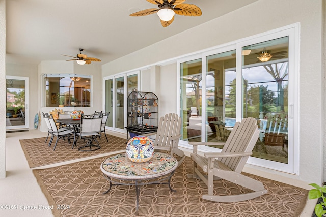 sunroom featuring ceiling fan