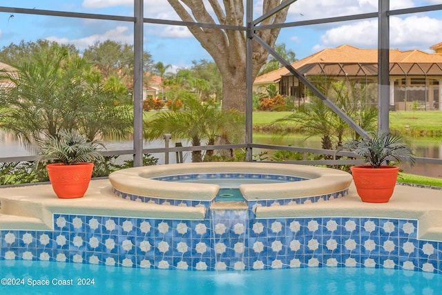 view of swimming pool featuring a lanai, a patio, and an in ground hot tub