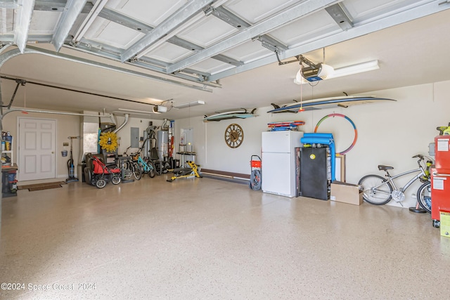 garage featuring a garage door opener, freestanding refrigerator, electric panel, and water heater