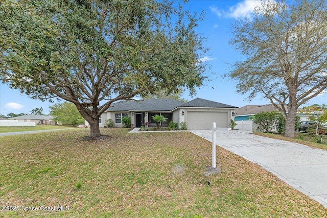 ranch-style house with an attached garage, driveway, fence, and a front yard