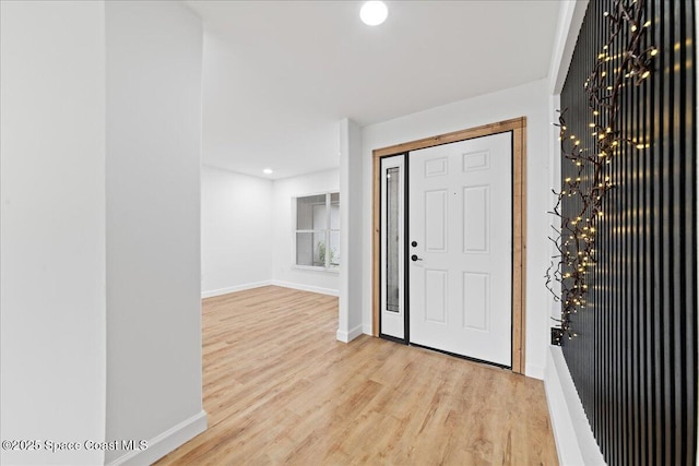 foyer entrance featuring light wood finished floors, recessed lighting, and baseboards