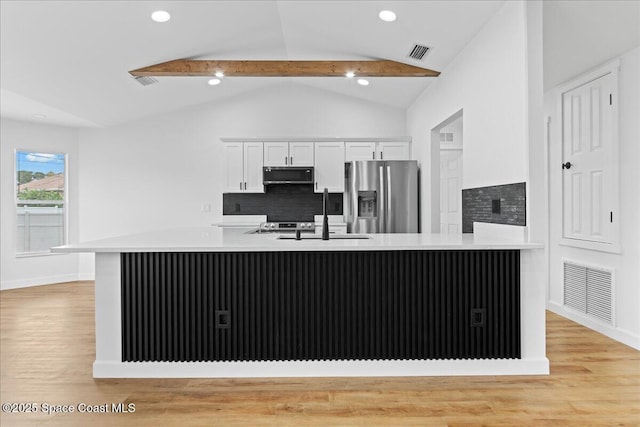 kitchen with stainless steel appliances, visible vents, a sink, and white cabinetry