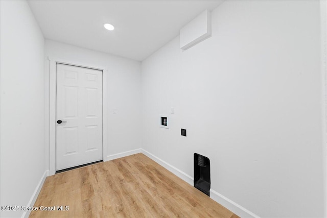 laundry area with laundry area, washer hookup, light wood-type flooring, and baseboards