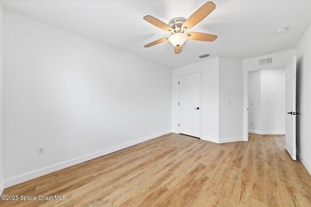 unfurnished bedroom featuring baseboards, visible vents, and wood finished floors