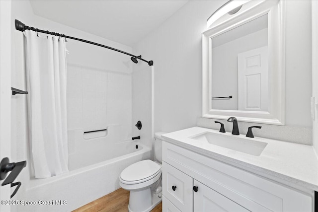 bathroom with toilet, shower / bath combo, wood finished floors, and vanity