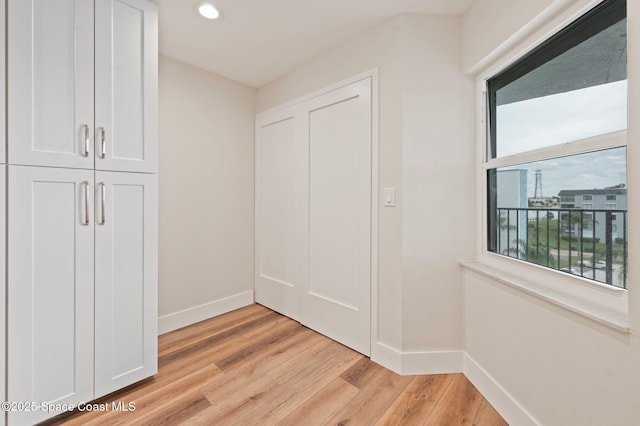 interior space with light wood-type flooring, baseboards, and recessed lighting