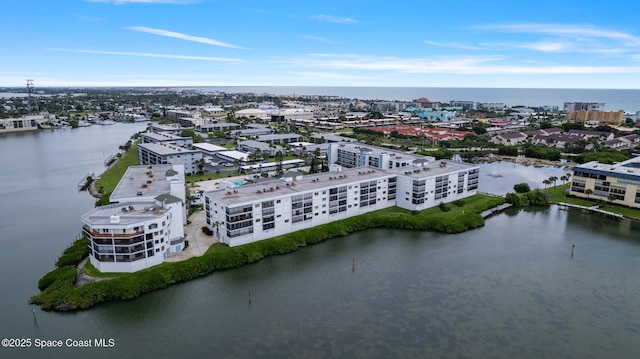 birds eye view of property featuring a water view and a city view