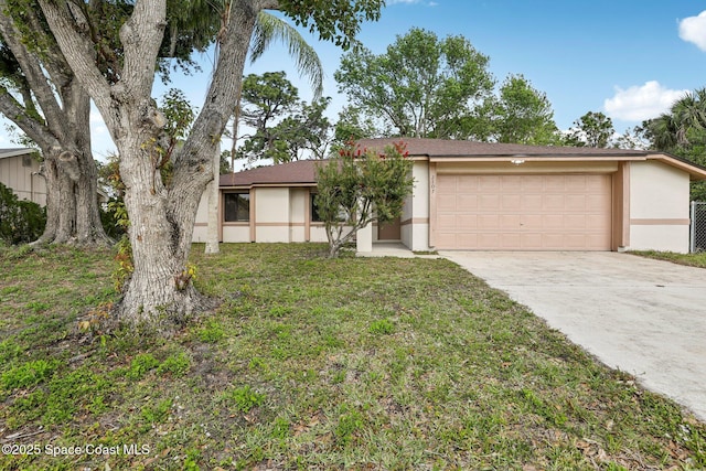 view of front facade featuring stucco siding, a front yard, concrete driveway, and an attached garage