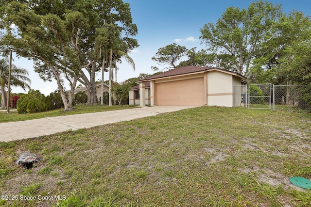 view of front of house featuring stucco siding, concrete driveway, a front lawn, and a gate