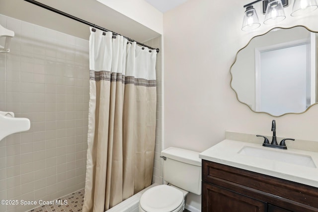 bathroom featuring vanity, toilet, and tiled shower