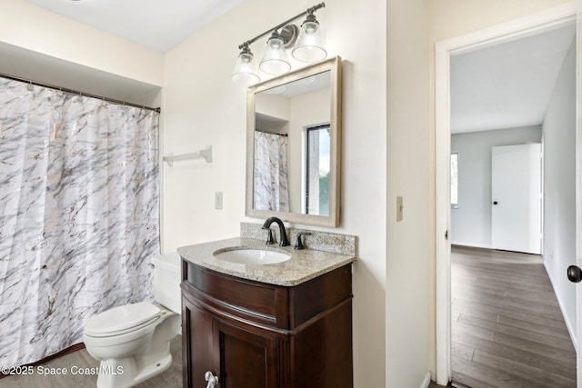 bathroom featuring vanity, a shower with shower curtain, toilet, and wood finished floors