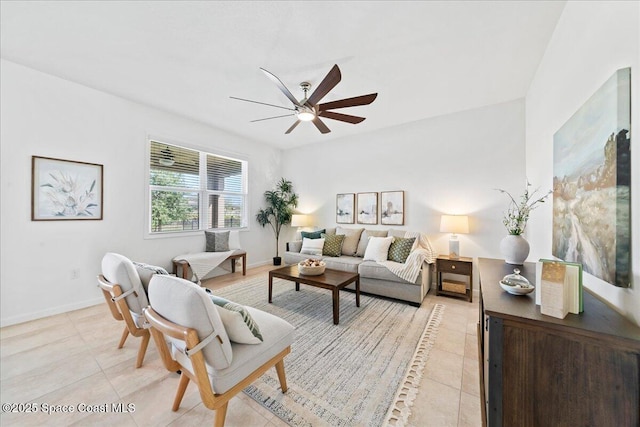 living room featuring light tile patterned floors, ceiling fan, and baseboards