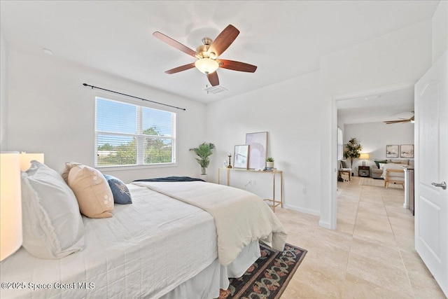 bedroom with light tile patterned floors, ceiling fan, visible vents, and baseboards