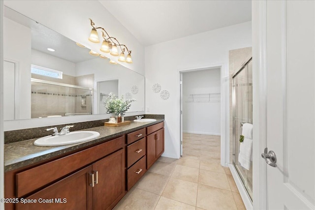 full bath with a sink, a shower stall, and double vanity