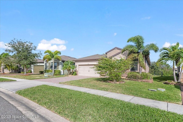 view of property hidden behind natural elements featuring a garage, driveway, a front lawn, and stucco siding