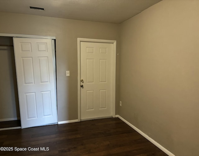 1341 S Patrick Dr, Satellite Beach, FL 32937 - interior space with dark wood-style floors, baseboards, and a closet
