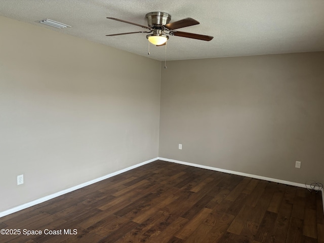 1341 S Patrick Dr, Satellite Beach, FL 32937 - spare room featuring baseboards, visible vents, dark wood finished floors, and a textured ceiling