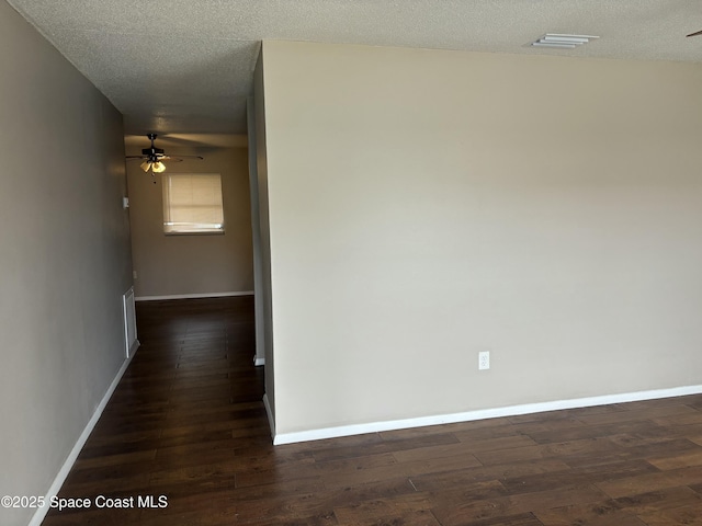 1341 S Patrick Dr, Satellite Beach, FL 32937 - hallway featuring dark wood-style floors, a textured ceiling, and baseboards