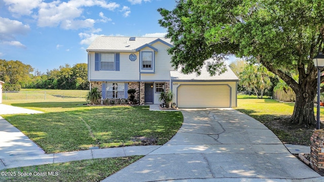 view of front of property featuring brick siding, an attached garage, a front yard, fence, and driveway