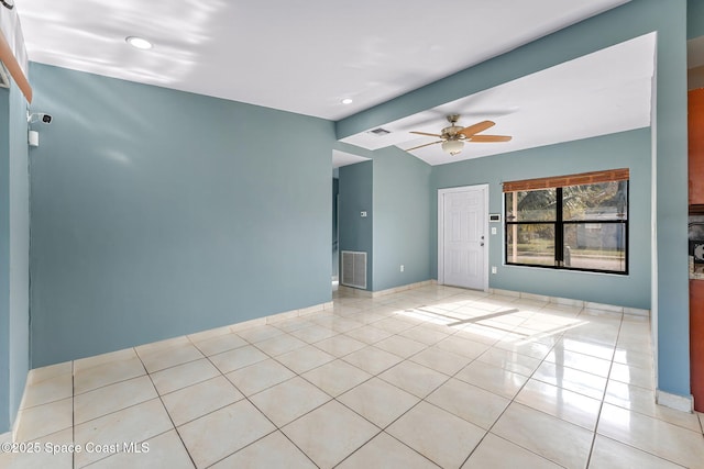 empty room with lofted ceiling with beams, tile patterned flooring, visible vents, baseboards, and a ceiling fan