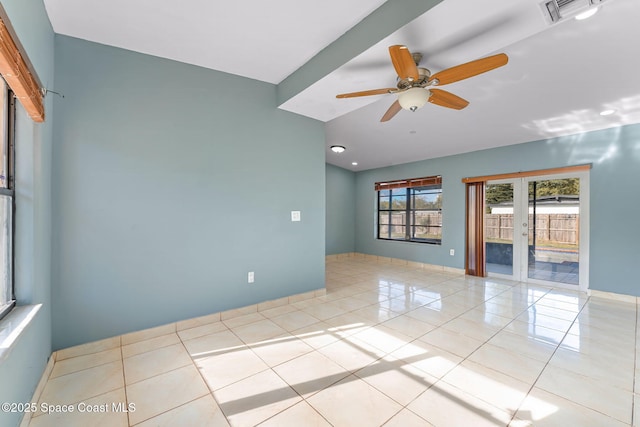 tiled spare room with a ceiling fan, french doors, visible vents, and baseboards