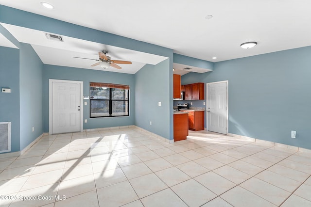 kitchen with light tile patterned floors, visible vents, brown cabinetry, and open floor plan