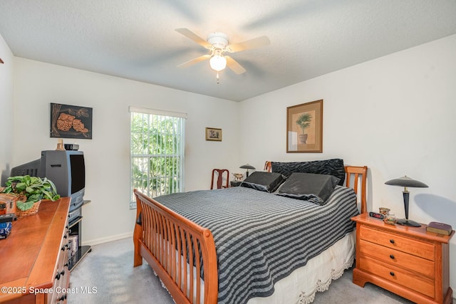 bedroom with a textured ceiling, baseboards, a ceiling fan, and light colored carpet