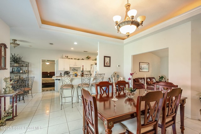 dining room with visible vents, a raised ceiling, an inviting chandelier, crown molding, and light tile patterned flooring