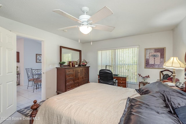 bedroom with a ceiling fan and light tile patterned flooring