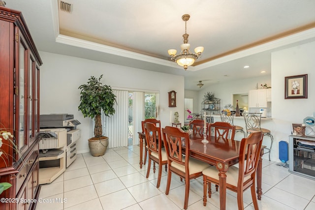 dining space featuring a raised ceiling, a notable chandelier, and light tile patterned floors