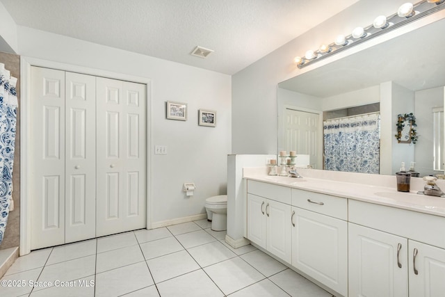 bathroom featuring visible vents, toilet, a shower with curtain, tile patterned floors, and a textured ceiling