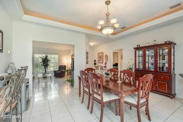 dining space featuring light tile patterned floors, a raised ceiling, visible vents, and an inviting chandelier