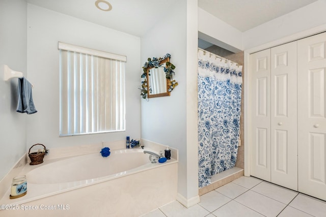 bathroom featuring tile patterned flooring, a closet, a shower stall, and a bath