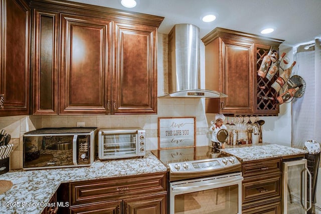 kitchen with a toaster, wall chimney range hood, stainless steel range with electric stovetop, and tasteful backsplash