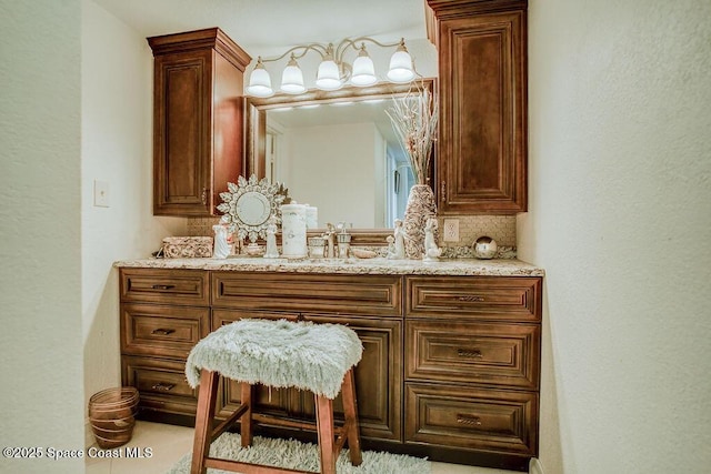bathroom with tasteful backsplash and vanity