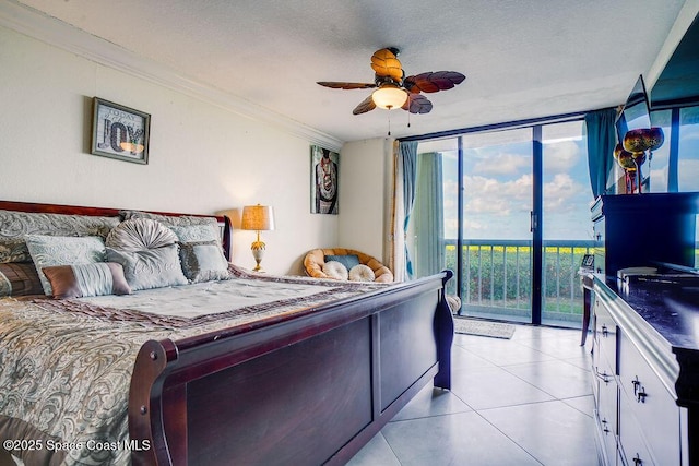 bedroom with light tile patterned floors, ornamental molding, ceiling fan, a wall of windows, and access to outside