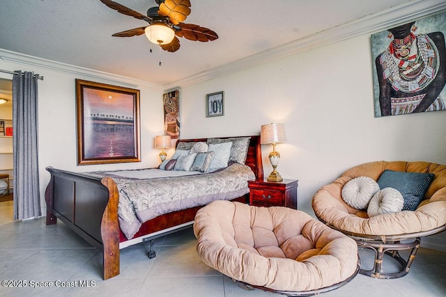 bedroom with ornamental molding, tile patterned flooring, and a ceiling fan