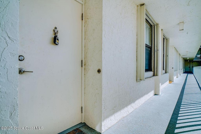 entrance to property featuring stucco siding