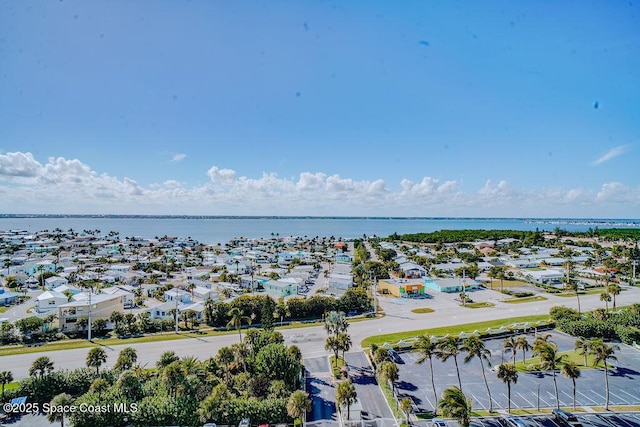drone / aerial view with a water view and a residential view