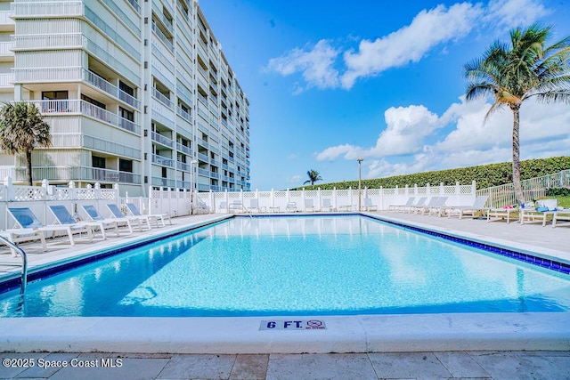 pool featuring a patio area and fence