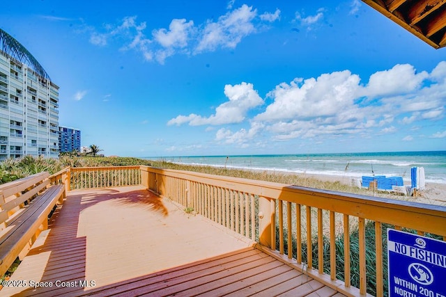 deck with a water view and a beach view