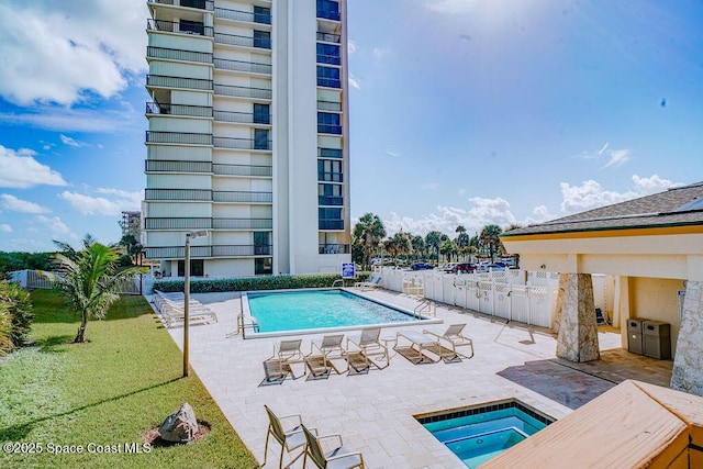community pool with a yard, a patio, and a hot tub