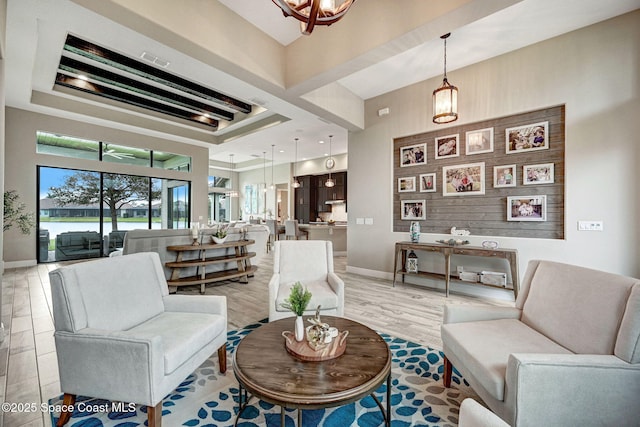 3882 Durksly Dr, Melbourne, FL 32940 - living room with light wood finished floors, a towering ceiling, visible vents, and baseboards