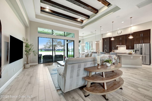 3882 Durksly Dr, Melbourne, FL 32940 - living room with light wood finished floors, a high ceiling, and baseboards