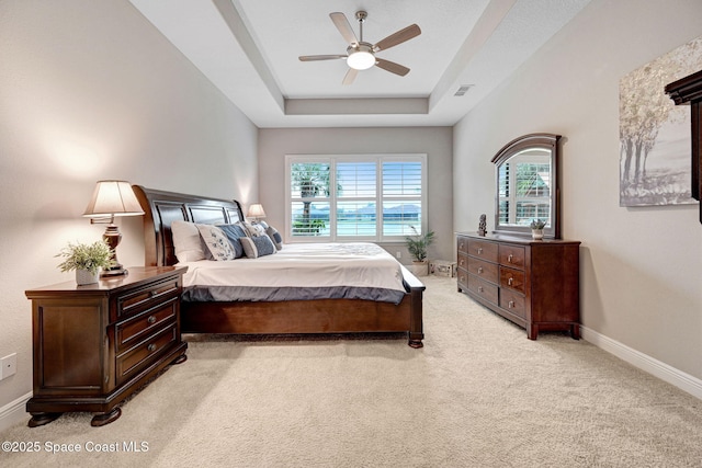 3882 Durksly Dr, Melbourne, FL 32940 - bedroom with a tray ceiling, visible vents, light carpet, ceiling fan, and baseboards