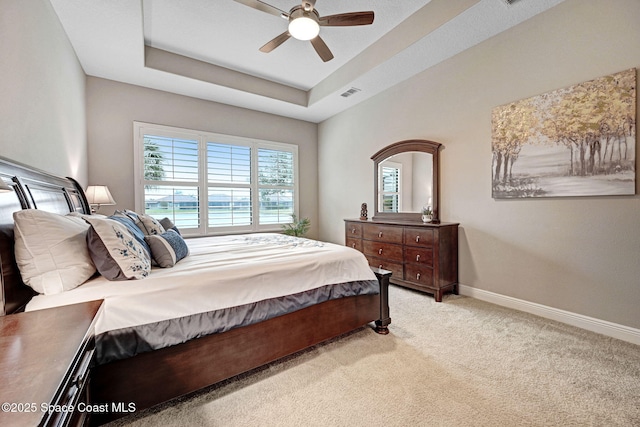 3882 Durksly Dr, Melbourne, FL 32940 - bedroom featuring ceiling fan, carpet flooring, visible vents, baseboards, and a raised ceiling