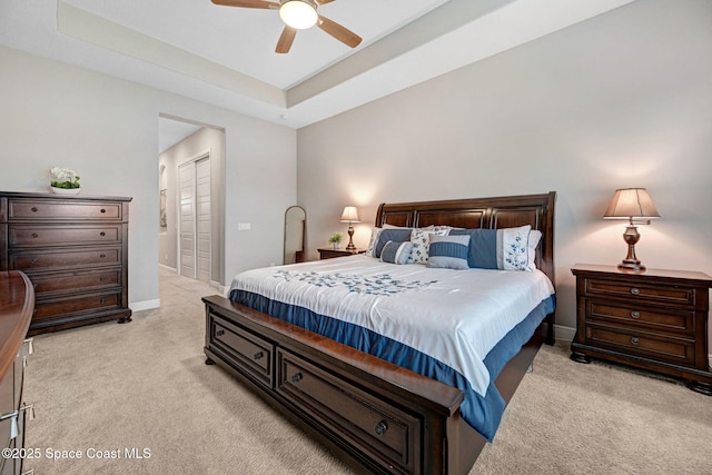 3882 Durksly Dr, Melbourne, FL 32940 - bedroom with light colored carpet, a ceiling fan, baseboards, a closet, and a tray ceiling