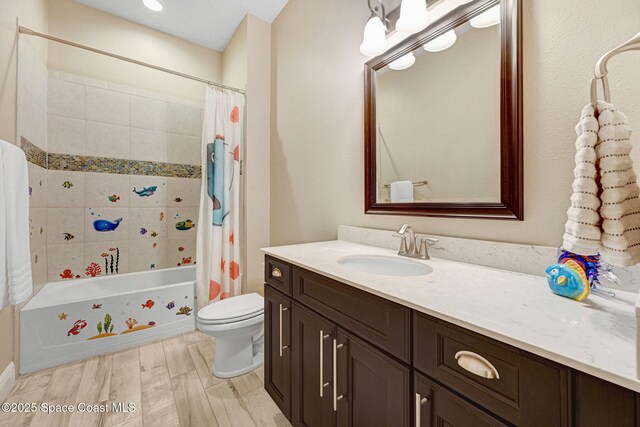 3882 Durksly Dr, Melbourne, FL 32940 - bathroom featuring shower / bath combo, vanity, toilet, and wood finished floors