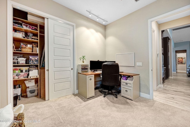 3882 Durksly Dr, Melbourne, FL 32940 - office area featuring light carpet, track lighting, and baseboards