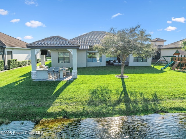 3882 Durksly Dr, Melbourne, FL 32940 - rear view of house with a patio area, a tiled roof, a yard, and a playground